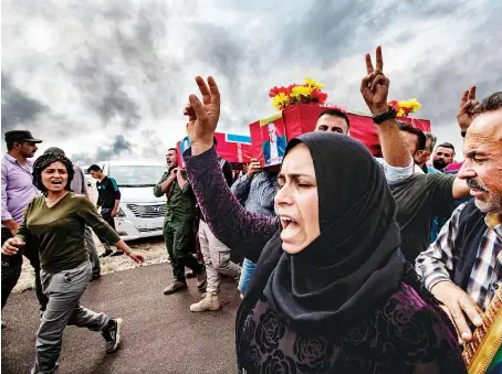  ?? AFP ?? Mourners near the Syrian Kurdish border town of Ras Al-Ain attend the funeral of civilians and fighters, who died in attacks by Turkish-led forces.