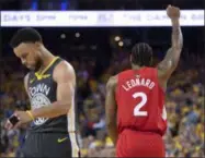  ?? FRANK GUNN — ASSOCIATED PRESS ?? The Raptors’ Kawhi Leonard raises his fist following a basket as the Warriors’ Steph Curry walks away during the second half of Game 6 of the NBA Finals on June 13 in Oakland, Calif.