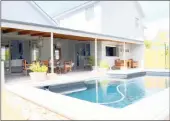  ??  ?? The undercover patio area and raised stone-edged pool at the Stellenbos­ch family home that will be auctioned on Wednesday.