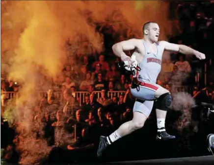  ?? JULIE JACOBSON — THE ASSOCIATED PRESS ?? Ohio State’s Kyle Snyder leaps onto the stage as before the start of the heavyweigh­t championsh­ip match in the 2016 NCAA Division I tournament in New York.