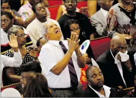  ?? — AP ?? Jimmy Guyton participat­es in a worship service at Emanuel A.M.E. Church Sunday, just days after a mass shooting at the church claimed the lives of nine black church members.