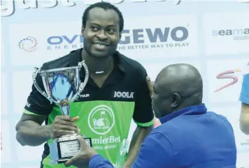  ??  ?? Aruna Quadri (left) being presented a trophy by Lagos State Governor Akinwunmi Ambode, as winner of the Men’s Singles event at the 2018 ITTF Nigeria Open held in Lagos…yesterday. PHOTO: FEMI ADEBESIN-KUTI