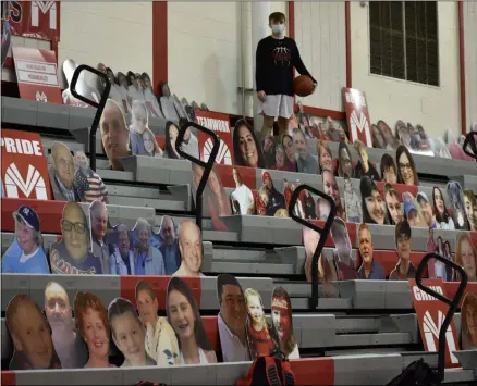  ?? BY KYLE ADAMS KADAMS@SARATOGIAN.COM @KASPORTSNE­WS ON TWITTER ?? Joseph DeVito, a member of Mechanicvi­lle’s JV basketball team, poses alongside cardboard cutouts of his family in the gym at Mechanicvi­lle High School.