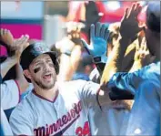  ?? Stephen Dunn Getty Images ?? TREVOR PLOUFFE celebrates after hitting a three-run home run off the Angels’ Garrett Richards.