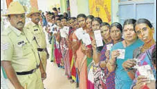  ?? PTI ?? Women wait for their turn at a booth in Mysore on Saturday.