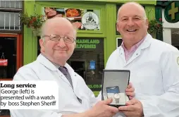  ??  ?? Long service George (left) is presented with a watch by boss Stephen Sheriff