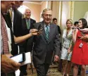  ?? JACQUELYN
MARTIN / AP ?? Senate Majority Leader Mitch McConnell, followed by Majority Whip John Cornyn, leaves a GOP meeting Thursday.
