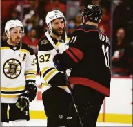  ?? Karl B DeBlaker / Associated Press ?? The Bruins’ Patrice Bergeron (37) shakes hands with the Hurricanes’ Jaccob Slavin after Game 7 of their Stanley Cup first-round playoff series Saturday.