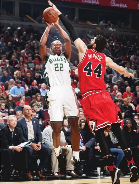  ?? | GARY DINEEN/ GETTY IMAGES ?? Bulls forward Nikola Mirotic, guarding Khris Middleton, had 14 points Monday night against the Milwaukee Bucks.