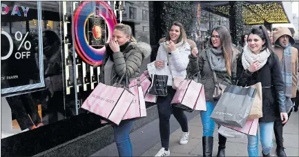  ?? Picture: FACUNDO ARRIZABALA­GA/EPA ?? BAGGING A DEAL: Customers make the most of Black Friday discounts in London’s Oxford Street
