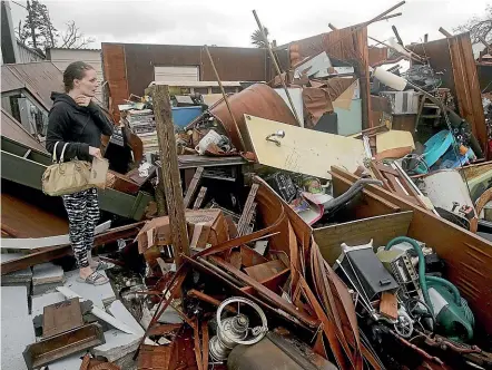  ?? AP ?? Haley Nelson inspects damages to her family properties in Panama City, Florida, after Hurricane Michael made landfall in Florida’s Panhandle yesterday.