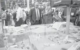  ?? Michael Ciaglo / Houston Chronicle ?? Bodley Thornton, right, of Noble Corp., explains a model of a subsea field to Secretary of the Interior Ryan Zinke at the OTC this week.