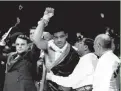  ?? AP ?? Joe Louis acknowledg­es the crowd after becoming the new world heavyweigh­t champion with a knockout of Jim Braddock in Chicago on June 22, 1937.