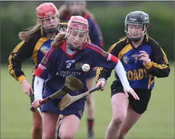  ??  ?? Ailis Neville makes a piercing run through the Castlecome­r defence as Caoimhe Hennessy looks on.