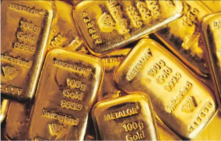  ?? CHRIS RATCLIFFE/ BLOOMBERG FILES ?? Gold is on the radar of more investors so far this year. The precious metal traded at US$1,338.39 per ounce on Friday, on the back of strong production outlooks from companies, higher price prediction­s from bank analysts and merger activity.