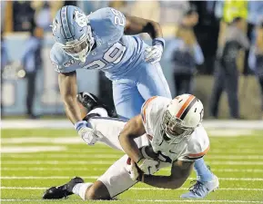  ?? GRANT HALVERSON/GETTY IMAGES ?? Virginia’s Terrell Jana makes a catch against North Carolina’s Storm Duck during the first half on Saturday night in Chapel Hill, N.C. Jana caught 13 passes for 146 yards.