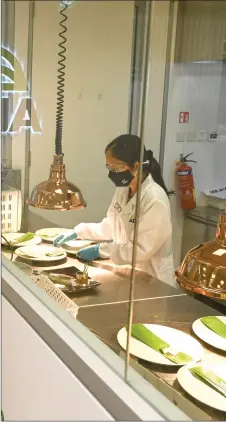  ??  ?? Photograph shows a staff member preparing plant-based food samples.