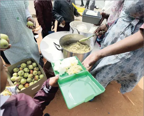  ??  ?? Women dish out lunch to kids at Inkwenkwen­zi Primary School in Diepkloof, Soweto. The school feeding project was started with much fanfare as a nutrition solution to the millions of learners from poor homes, but the writer says it has been corrupted...