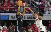  ?? BEN MCKEOWN — THE ASSOCIATED PRESS ?? Kansas State’s Cymone Goodrich (2) attempts to shoot over North Carolina State’s Diamond Johnson (0) during the first half in the second round of the NCAA Tournament in Raleigh, N.C., on Monday.