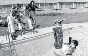  ??  ?? Alan is dumped in a pool by band-mates during the days of Rollermani­a Singing sensations on roller skates Cheers