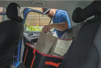  ?? Santiago Mejia / The Chronicle 2018 ?? DoorDash driver Aaron Powell delivers an order in Berkeley, which is the first city in the East Bay to cap fees that food delivery apps can charge while pandemic health orders are in place.