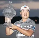  ?? JOHN MCCALL/SUN SENTINEL ?? Sungjae Im holds up his trophy after winning the Honda Classic at PGA National in Palm Beach Gardens.