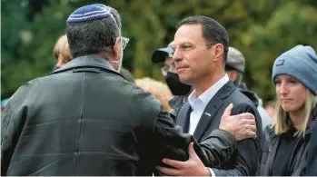  ?? GENE J. PUSKAR/AP ?? Pennsylvan­ia Attorney General Josh Shapiro, center, attends a Commemorat­ion Ceremony in Schenley Park, in Pittsburgh’s Squirrel Hill neighborho­od, on Oct. 27, 2021, three years after a gunman killed 11 worshipers at the Tree of Life Synagogue.