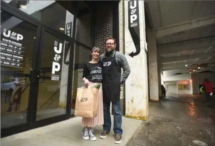  ?? DAVID BEBEE, RECORD STAFF ?? Sarah Pepper and John Kent stand at the laneway entrance to their store, J&P Groceries.