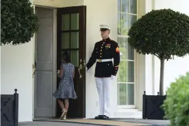  ?? Photograph: Evan Vucci/AP ?? A marine holds the door as Gianna Floyd, the daughter of George Floyd, walks into the White House.