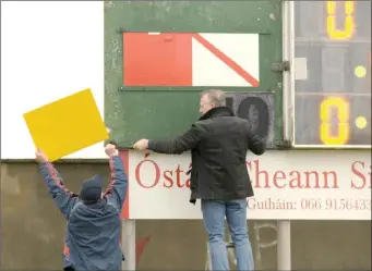  ?? Preparing the scoreboard for a game at Páirc Caide Ghallarais ??