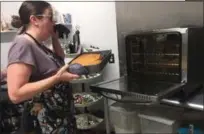  ?? PEG DEGRASSA - MEDIANEWS GROUP ?? Josie Platt, of Havertown, puts a cake in the oven at The West Branch Baking Co. in Brookhaven, where she works full time.