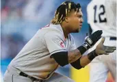  ?? JOHN MINCHILLO/AP ?? The Cleveland Guardians’ Jose Ramirez reacts after reaching third base on a throwing error after hitting a double against the New York Yankees during the 10th inning of Game 2 of the ALDS on Friday in New York.