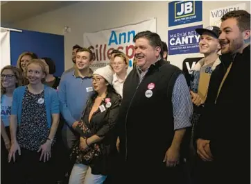  ?? ERIN HOOLEY/CHICAGO TRIBUNE ?? Democratic Gov J.B. Pritzker greets supporters during a canvass kickoff event at state Sen. Ann Gillespie’s campaign office with Gillespie and state Rep. Mark Walker in Arlington Heights on Saturday.