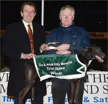  ??  ?? Declan Dowling, KGS manager, presents the winner’s trophy on behalf of the sponsors to winning trainer/owner Timmy Carmody, from Ardfert, after Carmac Express won the Con & Annie Kirby Memorial Trial Stake Final at the Kingdom Greyhound Stadium on...