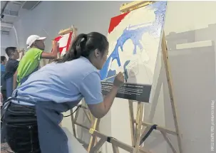  ??  ?? A Thai participan­t takes part in the movie poster hand-painting challenge during the recent eight-country Asia Super Team competitio­n in Taiwan.