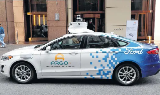  ?? REUTERS ?? An Argo Ai self driving prototype vehicle is seen outside a Ford and Volkswagen joint news conference in New York City.