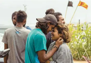  ?? BUDDHIKA WEERASINGH­E/GETTY ?? Demonstrat­ors embrace Friday as they prepare to leave a protest camp in Colombo, Sri Lanka, near the president’s offices. Protesters occupied the camp, located in a large oceanside park, during months of anti-government unrest amid the island country’s economic crisis. Police ordered protesters to vacate the site by 5 p.m. Friday.