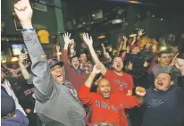  ?? STEVEN SENNE/ASSOCIATED PRESS ?? Red Sox fans in Boston celebrate while watching on television as the Red Sox beat the Dodgers in Game 5 of the World Series on Sunday.