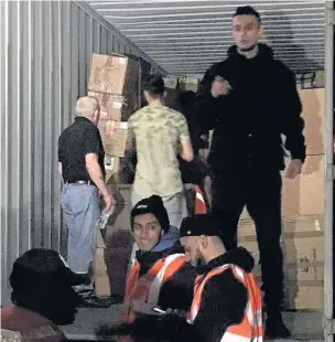  ??  ?? ●●The Rochdale Community Partnershi­p container being filled by volunteers