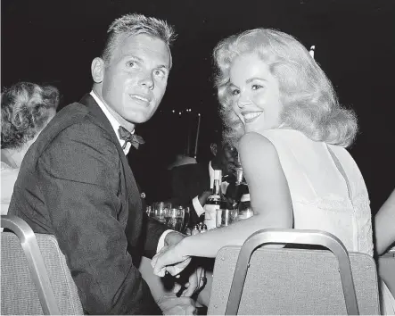  ?? THE ASSOCIATED PRESS ?? Tab Hunter, left, seen with Tuesday Weld at a 1959 reception in Los Angeles, was a heartthrob to millions of teen girls in the ’50s.