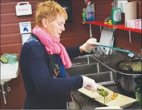  ?? FrAm DiNSHAW/THE NEWS ?? Shirley MacIntosh, a community sponsor for the Almetheb family, helps prepare a Syrian Dish for Culture Days.