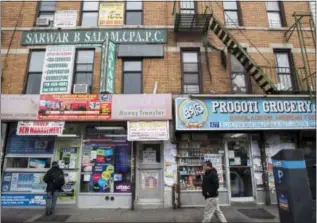  ?? THE ASSOCIATED PRESS ?? Bangladesh­i stores line McDonald Ave in the Kensington neighborho­od in Brooklyn on Tuesday. When an immigrant from Bangladesh set off a bomb in New York City’s subway system this week, he was the only person injured. But New York City’s vibrant...