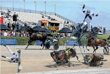  ??  ?? Driver Terry Chmiel goes flying in race five at Addington last month as Divinia Bellezza (12) takes a dive, with Held to Ransom (2) and driver Robbie Close also flat on the track.