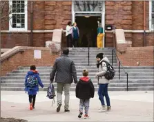  ?? File photo ?? Parents walk their students to class a Connecticu­t school recently.