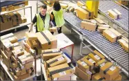  ?? Ross D. Franklin / Associated Press ?? Amazon.com employees organize outbound packages at an Amazon.com Fulfillmen­t Center in Phoenix.