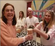  ?? PAUL POST — MEDIANEWS GROUP ?? Pat Markowski, left, of Clifton Park is all smiles as Tara Hnis, of the county Office for the Aging serves her an ice cream soda. Looking on are Sydney Cross and Dave Morabito.