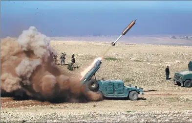  ?? KHALID AL-MOUSILY / REUTERS ?? Members of the Iraqi rapid response forces fire a missile toward Islamic State militants during a battle in the south of Mosul, Iraq on Sunday.