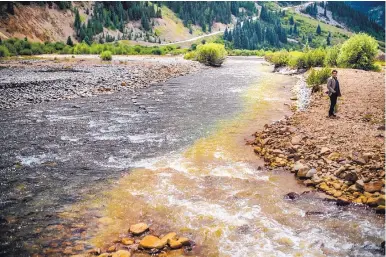  ?? ROBERTO E. ROSALES/JOURNAL ?? Cement Creek, which flows into the Animas River, was heavily contaminat­ed with orange sludge wastewater in 2015 from the Gold King Mine near Silverton, Colorado.