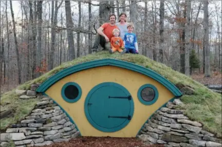  ?? JONATHAN GIFFIN VIA AP ?? In this undated photo provided by Wooden Wonders, Rocy and Melissa Pillsbury and their children sit atop a custom Hobbit House in Santa Fe, Tenn.