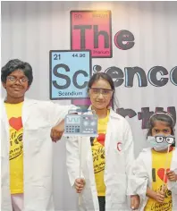  ??  ?? INSTANT CLICK... Kids dressed up as scientists pose with funprops at the photo booth of the Science Party arena.